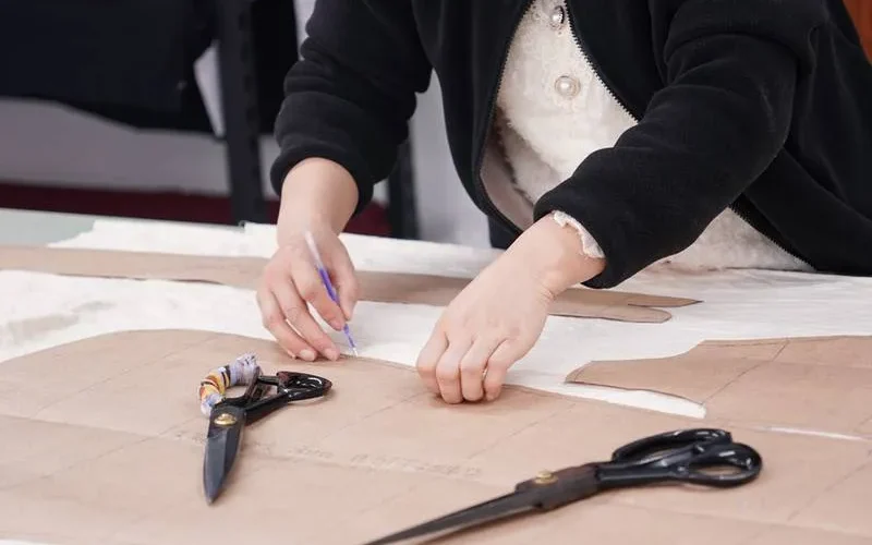 Cutting the fabric pieces by the paper templates